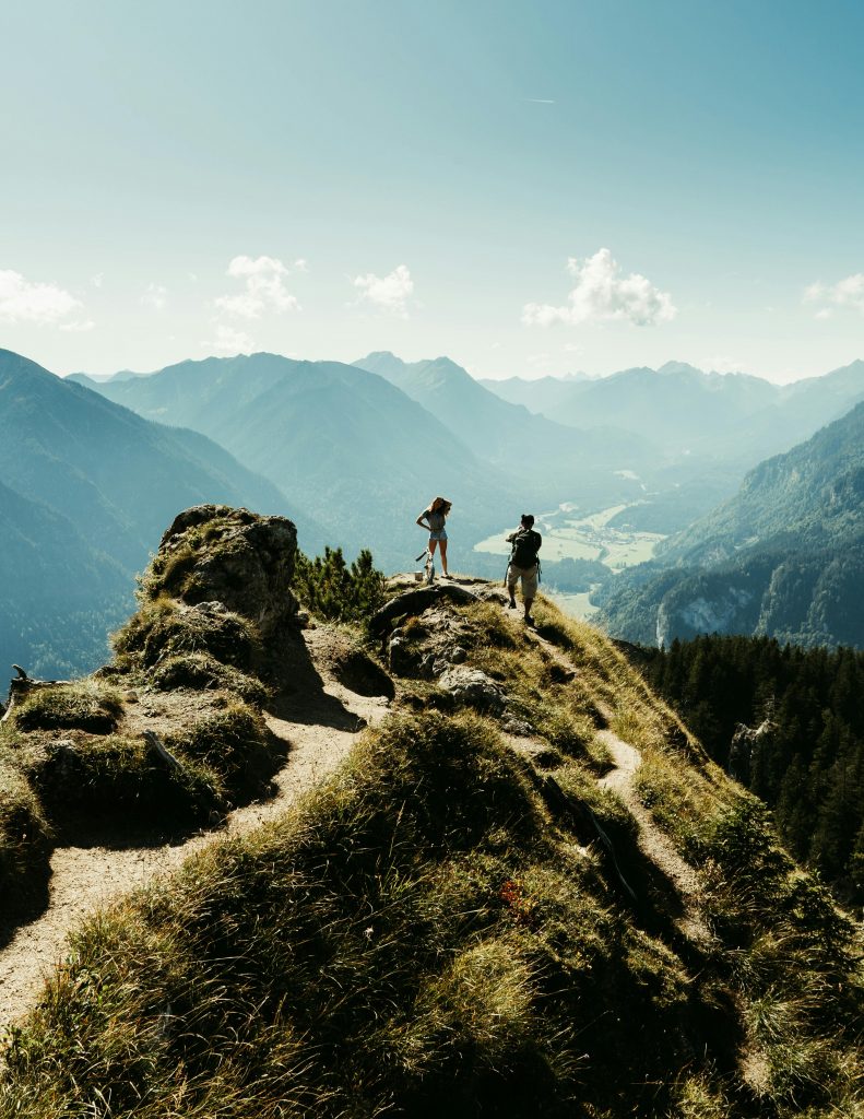 Hikers enjoy breathtaking views from a mountain peak in Garmisch-Partenkirchen.